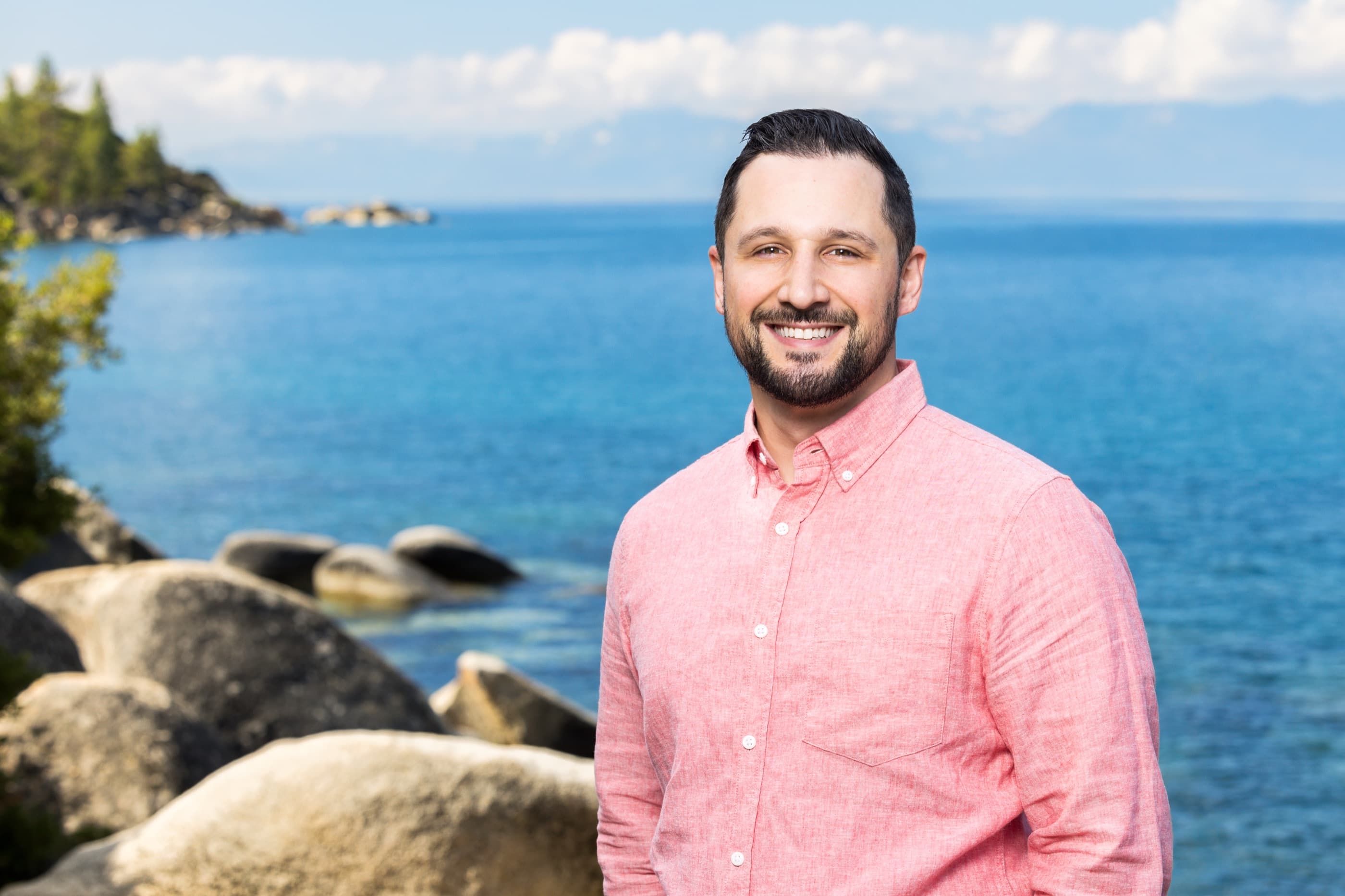 Joshua St. Laurent, CFP, CFT, Founder of Wealth In Yourself, smiling at the shore of Lake Tahoe